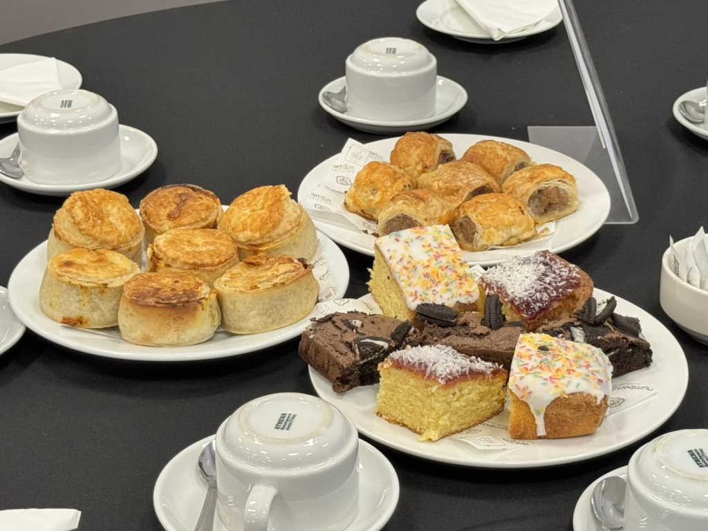 Sausage rolls, chicken curry pies, a selection of homemade cakes and teacups