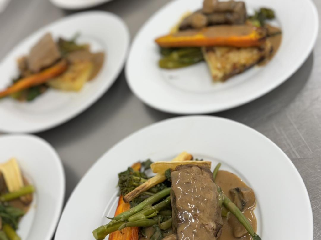 Slow cooked flat iron of beef, dauphinoise potatoes, mixed greens, honey roasted carrots, mushroom sauce