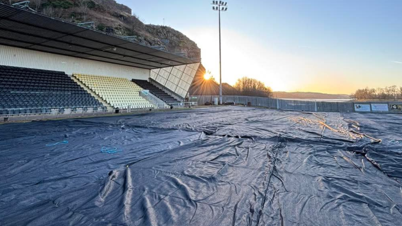 The pitch at The Marbill Coaches Stadium under frost covers