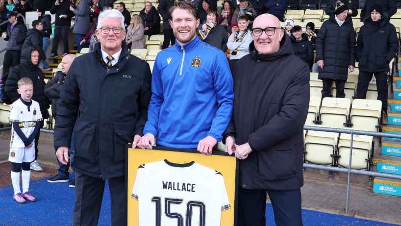 Dumbarton FC player Tony Wallace is presented with a shirt to mark 150 games for the club by legends Roy McCormack and Lawrie Williams