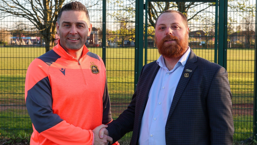 Dumbarton FC manager Frank McKeown shakes hands with Executive Director Cameron Watson after signing an extended deal