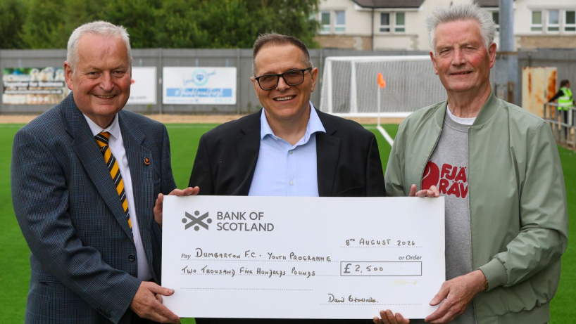 Robert Ryan and David Brownlee of the Sonstrust present Mario Lapointe of Dumbarton FC with a cheque for youth development